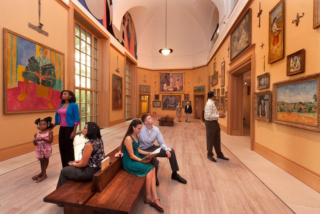 People sitting in a gallery room in the Barnes Foundation.